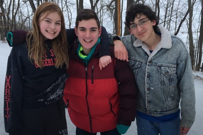 Small group outside at rock mountain in the snow.