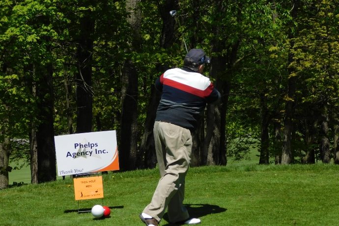 Golfer mid swing at rock mountain.