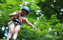 A young camper ziplining.