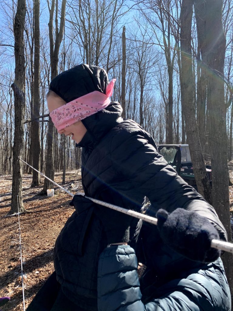 Girl in blindfold on team challenge course